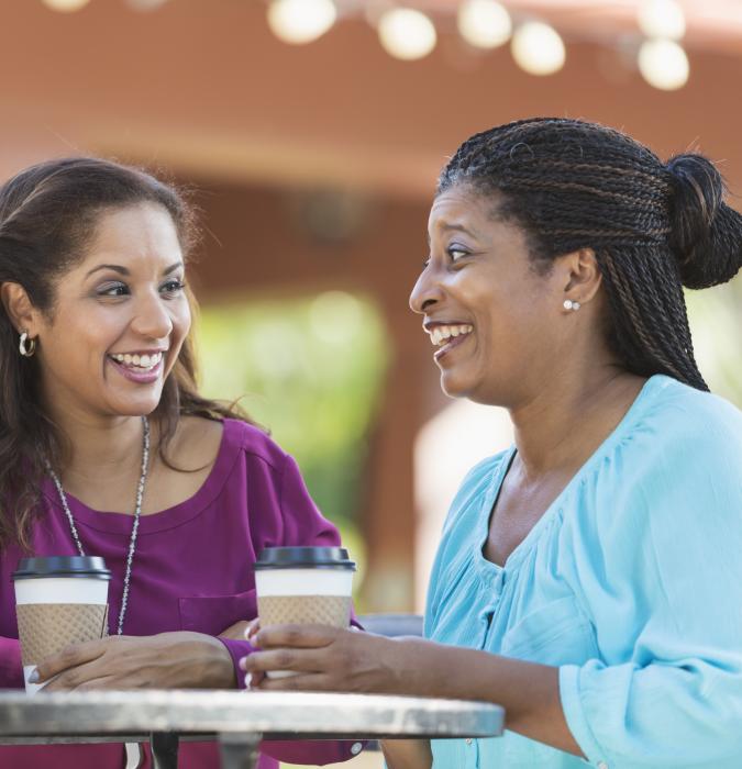 Diverse group of women talking over coffee 